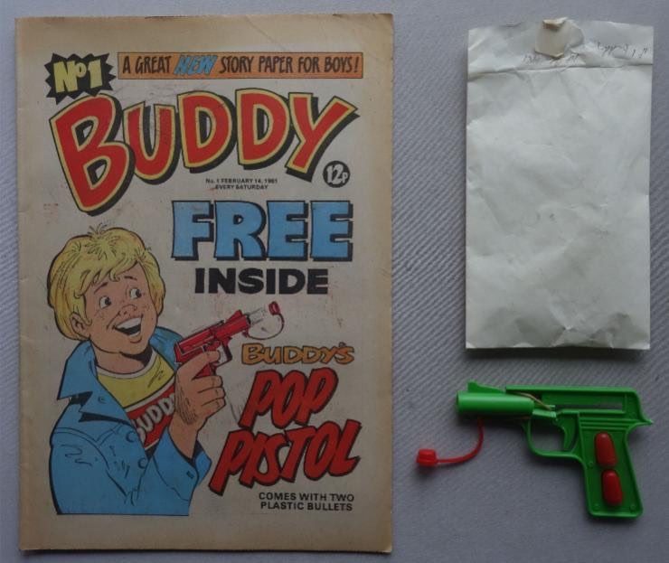 Buddy No. 1 cover dated 14th February 1981 With Free Gift - Pop Pistol. The free gift pop pistol appears to be unused. Both pellets are present as is the firing elastic band, which remains supple, and it comes in the original paper packet