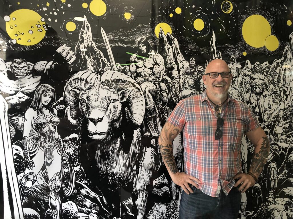 Liam Sharp in front of his mural in Forbidden Planet Derby
