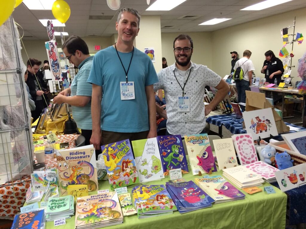 Dan with Bob Flynn, selling Heeby Jeeby Comix at the Massachusetts Independent Comics Expo (MICE). Photo via danmoynihan.com