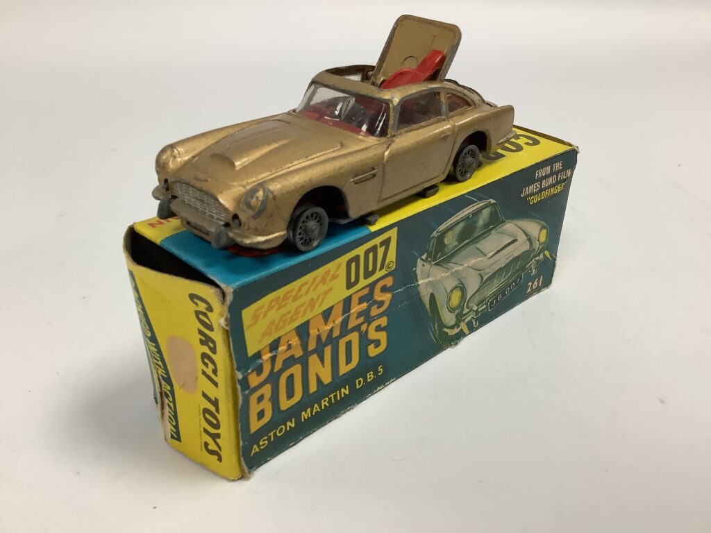 An original Corgi No.261 James Bond Aston Martin DB5. Overall fair condition, roof and front guns working, bulletproof guard stuck. Missing tyres and baddie.Boxed, missing insert, crushing, fading and tears to outer box. (Sheffield Auction Gallery Specialist Toys Auction 15th January 2026)