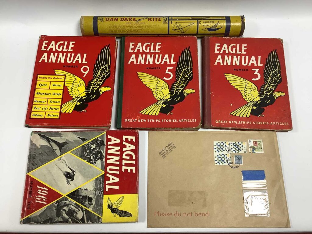 A Contemporary Dan Dare 'Spaceship' Kite, in original tube, plus a Dan Dare stamp and four Eagle annuals (5, 9, 3 and 1961) kite hard to find. (Sheffield Auction Gallery Specialist Toys Auction 15th January 2026)