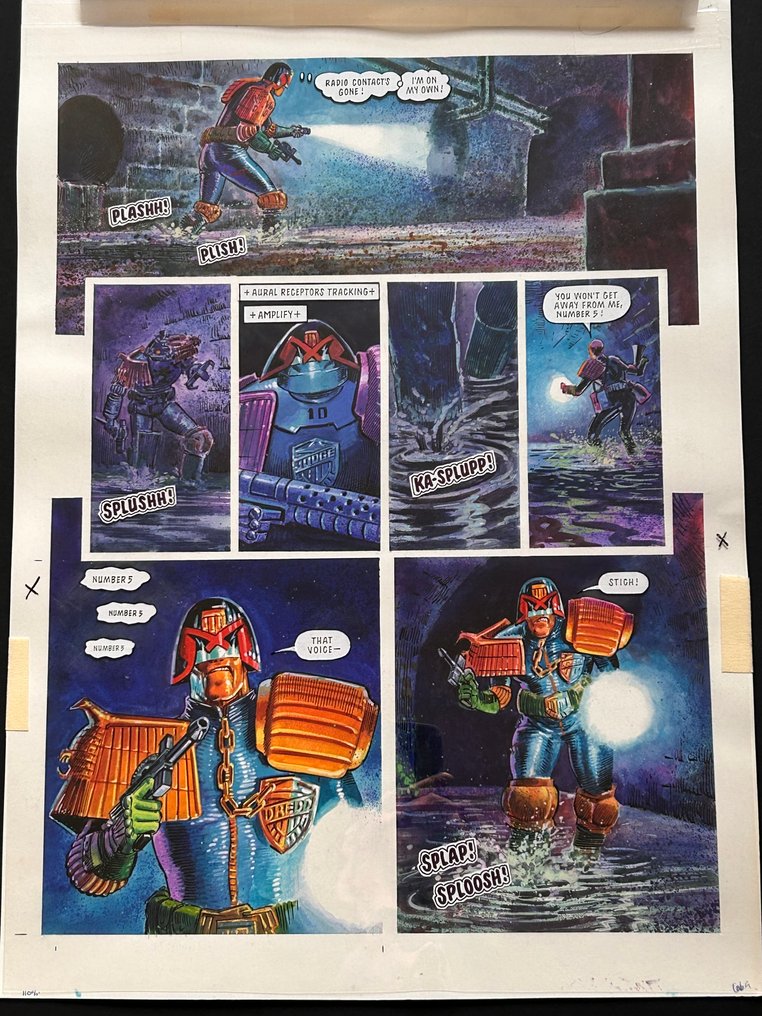 A stunning page of Judge Dredd artwork by Manuel Benet, first published in Judge Dredd Megazine No. 43 published in 1983. The lot includes the artwork and cover acetate with word balloons, and publisher mark up