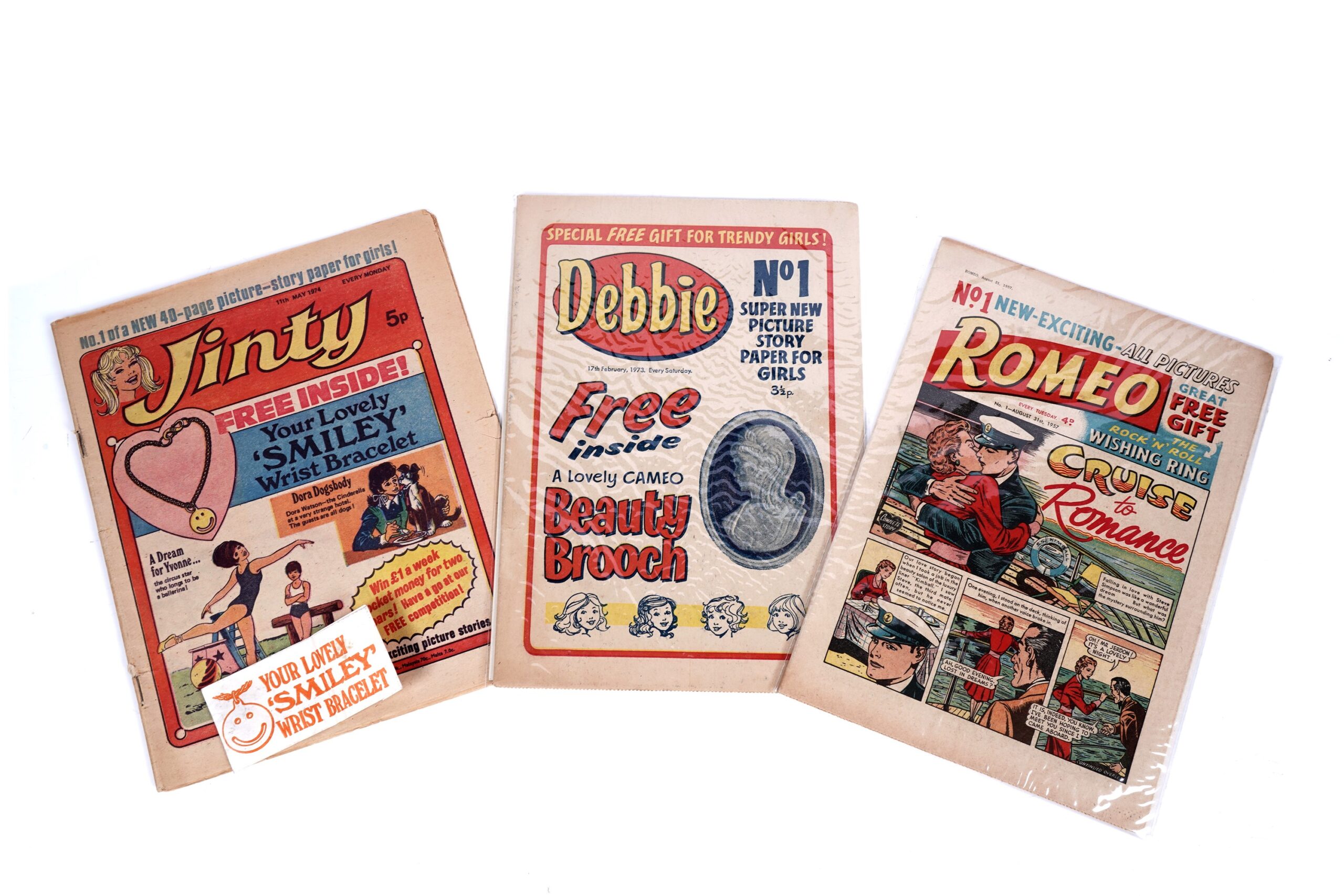 First issue comics for girls: Romeo No. 1, August 31st, 1957; Debbie No.1 17th February 1973; and Jinty No. 1, 11th May1974, with smiley wrist bracelet
