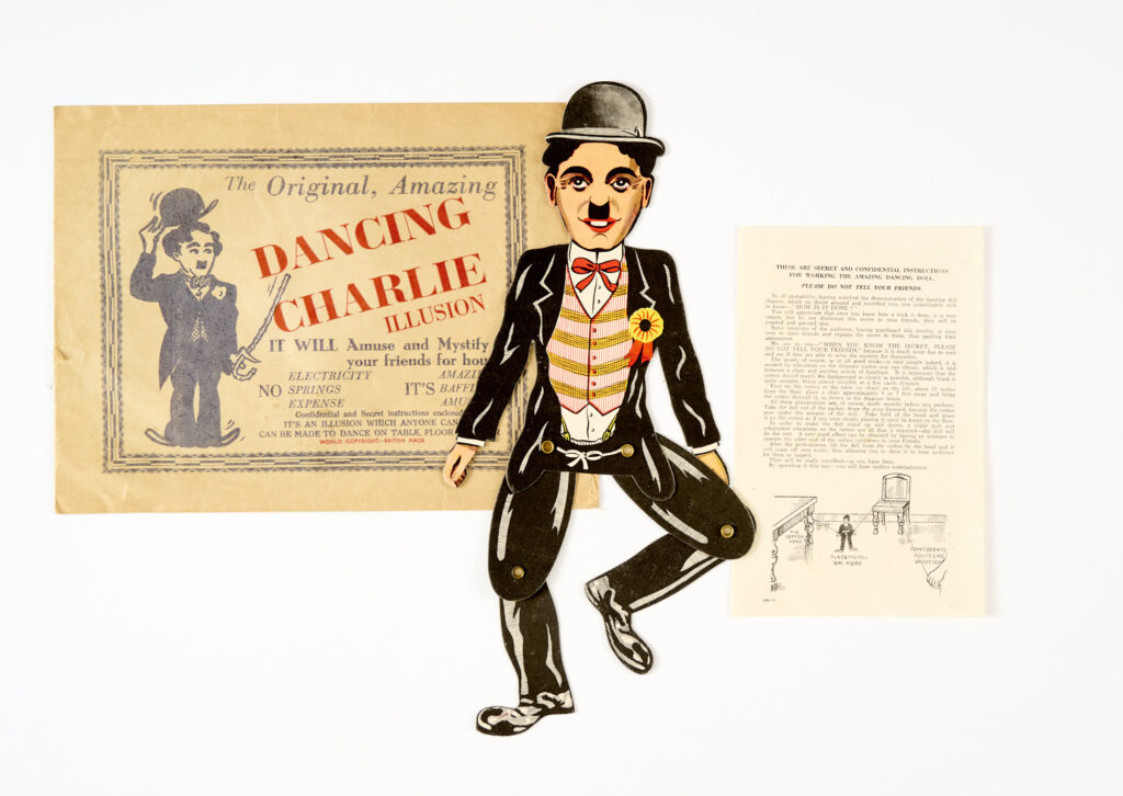 "The Original, Amazing Dancing Charlie Chaplin Illusion" (1930s). With secret instructions and original printed envelope. Charlie is 13 ins tall