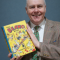 Auctioneer John Anderson with a copy of Beano Annual No.1 - sure to attract plenty of bids