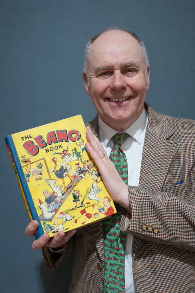 Auctioneer John Anderson with a copy of Beano Annual No.1 - sure to attract plenty of bids