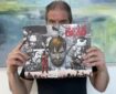 Charlie Adlard with a copy of a The Walking Dead Collection