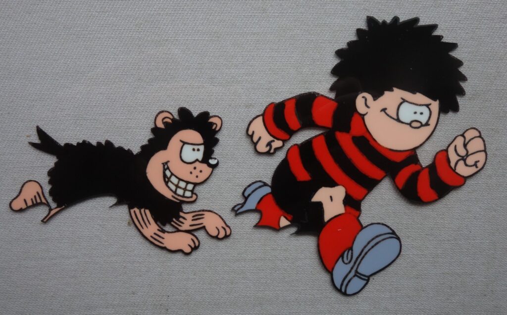 Dennis and Gnasher TV Series Animation Cel (1996), from the DC Thomson Archive. This is the first time any such cels from the two series have been offered for sale. This item has officially come from surplus material held by the DC Thomson Archive.

Dennis and Gnasher was an animated TV series broadcast on BBC from 2nd April 1996 until 7th May 1998. Re-runs aired on CBBC until January 2007. The series was produced by Collingwood O'Hare Productions and DC Thomson, in association with BBC Television. Largely written by Tony Collingwood, two series were made with 13 episodes in each, making a total of 26 episodes, running for 25 minutes each. The series focussed on Dennis the Menace and Gnasher, with voiceovers from voice actors and features the likes of Dennis' Mum and Dad, Granny, Curly, Pie-Face, Walter the Softy, and Foo Foo, amongst other smaller part characters based on the famous comic strip in The Beano.