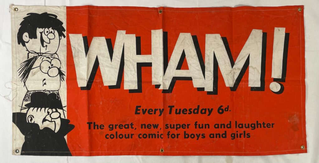 A scarce comic book advertising banner for WHAM!, approximately 45cm x 89cm
