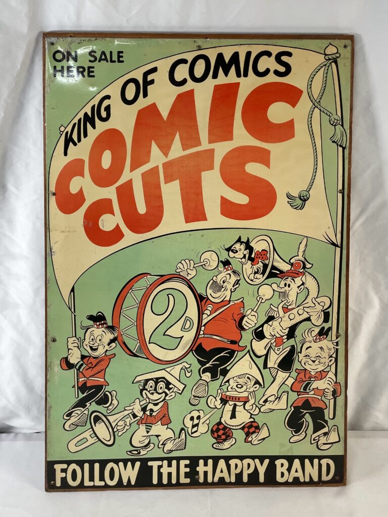 A tin plate comic book advertising sign advertising KING OF COMICS Comic Cuts mounted on a wooden frame, 76cm x 51cm (V)