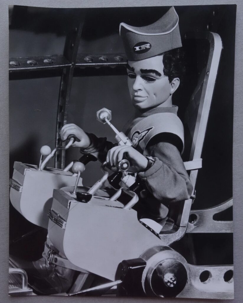 This photograph of Scott Tracy from "Thunderbirds", from the offices of TV 21, was used in an issue of the comic. From the estate of artist David Slinn. The photo was used by other licensors on other merchandise, including trading cards