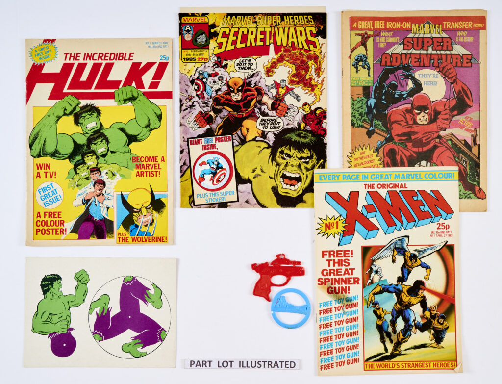 Superhero 80s No 1s most wfgs. Batman 1 wfg Bat Badge, Big Ben 1 wfg Cap, Captain America 1 wfg Superhero Sticker, Fantastic Four 1 wfg FF Boomerang, Incredible Hulk 1 wfg Hulk cardboard model, Marvel Action 1 wfg FF Superhero Sticker, Blockbuster 1, Punisher 1 wfg Badge, Savage Action 1, Marvel Super Heroes Secret Wars 2 wfgs Poster and Captain America Sticker, Super Adventure 1 wfg Black Panther Sticker, Marvel Team-Up 1, Valour 1, 2, both wfgs Devil Dinosaur Jigsaw parts and X-Men 1 wfg Spinner Gun [fn/vfn+] (15)